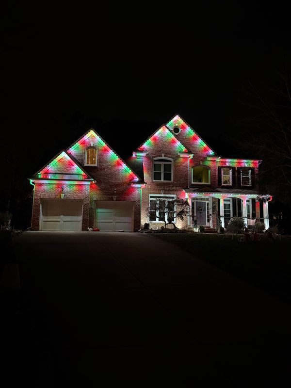 Permanent LED lighting on a brick home programmed to red and green for the holidays