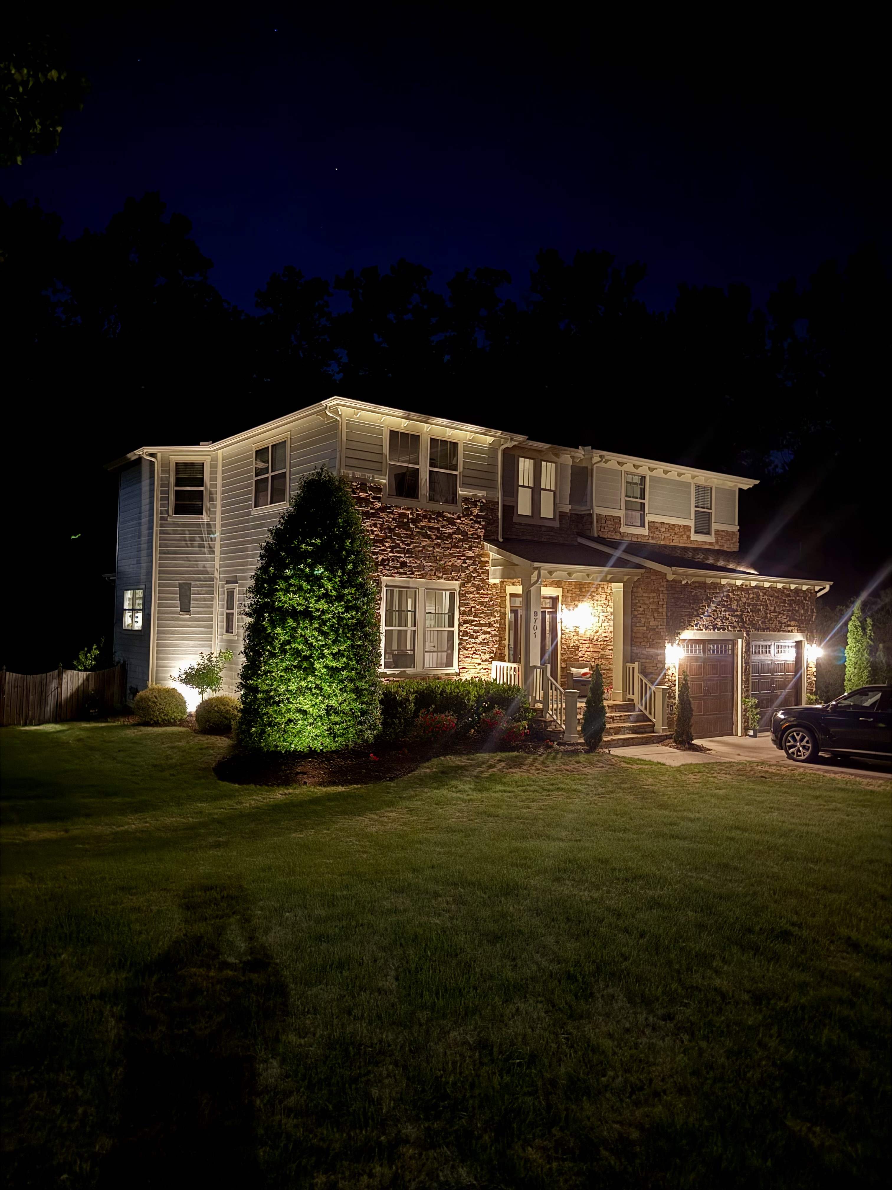 Stone facade grazing light, North Raleigh custom home