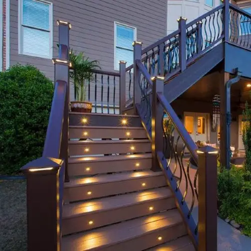 Step lights illuminating outdoor stair risers