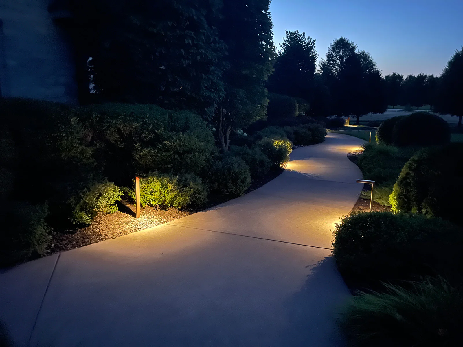 Mushroom and tier pathway lights along a residential walkway