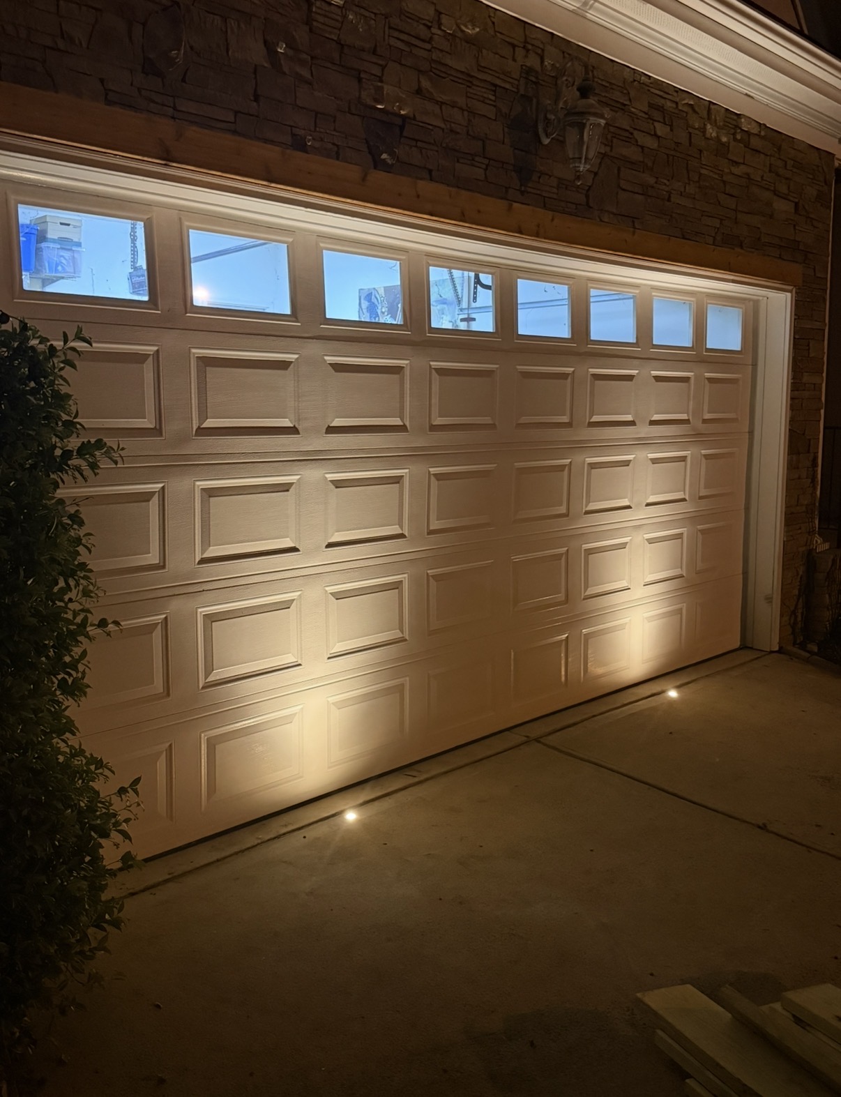 In-ground well lights illuminating a paver driveway in Raleigh NC