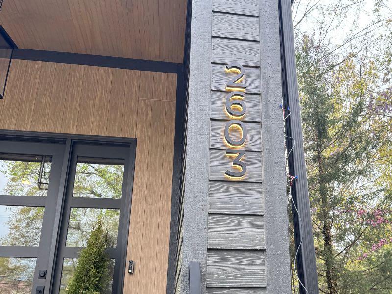 Premium illuminated house numbers with hidden wiring in a modern exterior installation